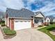 Charming home with a well-maintained front yard, brick accents, and a two-car garage at 3205 E 102Nd Pl, Thornton, CO 80229