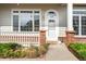 Inviting front entrance with brick accents and a charming welcome mat at 3205 E 102Nd Pl, Thornton, CO 80229