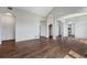 Spacious living room with hardwood floors and archways, leading to the dining area at 3205 E 102Nd Pl, Thornton, CO 80229