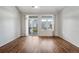 Bright living room features beautiful wood floors and a sliding glass door to the outside at 3205 E 102Nd Pl, Thornton, CO 80229