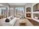 Living room with hardwood floors, fireplace, large windows, and comfortable seating at 3205 E 102Nd Pl, Thornton, CO 80229