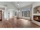 Bright and airy living room with hardwood floors, fireplace, and large windows at 3205 E 102Nd Pl, Thornton, CO 80229