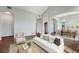 Bright living room with hardwood floors, neutral walls, and an open floor plan at 3205 E 102Nd Pl, Thornton, CO 80229