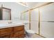 Bathroom with wooden vanity, tile countertop, and a glass-enclosed shower at 11196 E Baltic Dr, Aurora, CO 80014