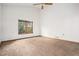 Empty bedroom featuring neutral carpet and a window overlooking the backyard at 11196 E Baltic Dr, Aurora, CO 80014