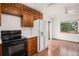 A kitchen featuring wooden cabinets, white appliances, and light-colored walls at 11196 E Baltic Dr, Aurora, CO 80014