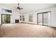 Bright living room featuring a fireplace, large windows, and a sliding glass door at 11196 E Baltic Dr, Aurora, CO 80014