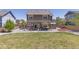 Wide backyard featuring a stone patio, lawn, hot tub, and a privacy fence at 217 Peabody St, Castle Rock, CO 80104
