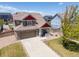 Lovely two-story house showcasing a well-kept lawn, long driveway, charming front porch, and a neatly landscaped yard at 217 Peabody St, Castle Rock, CO 80104
