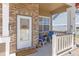 Inviting front porch with chairs, plants, and a 'Welcome' sign, creating a warm and friendly entrance to the home at 217 Peabody St, Castle Rock, CO 80104