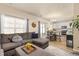 Spacious living room open to the kitchen, featuring a comfortable sectional sofa and plenty of natural light at 217 Peabody St, Castle Rock, CO 80104