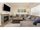 Comfortable living room featuring a fireplace, TV, and a large sectional sofa, ideal for relaxation and entertainment at 217 Peabody St, Castle Rock, CO 80104
