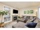 Cozy living room with a stone fireplace, TV, built-in shelving, and a comfortable sectional sofa at 217 Peabody St, Castle Rock, CO 80104