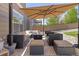 Inviting back patio with stylish furniture, a fire pit, and shaded area at 217 Peabody St, Castle Rock, CO 80104