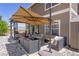 Back patio area with comfortable lounge furniture and shade umbrella at 217 Peabody St, Castle Rock, CO 80104