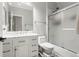 Bright bathroom with a marble countertop, shower with glass doors, and a large mirror at 3818 S Dallas St, Aurora, CO 80014