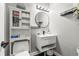 Modern bathroom with floating vanity, round mirror, and stylish storage at 3818 S Dallas St, Aurora, CO 80014