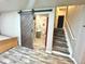 Stylish bathroom featuring a barn door, modern vanity and walk-in shower at 3818 S Dallas St, Aurora, CO 80014