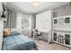 Stylish bedroom featuring a Murphy bed with built-in cabinets, and neutral-toned curtains at 3818 S Dallas St, Aurora, CO 80014