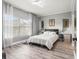 Serene bedroom with large window, neutral decor, and comfortable furnishings at 3818 S Dallas St, Aurora, CO 80014
