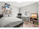 Cozy bedroom with light gray walls, wood floors, and a window with natural light at 3818 S Dallas St, Aurora, CO 80014
