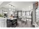 Open dining area featuring elegant lighting and seamlessly connected with the kitchen at 3818 S Dallas St, Aurora, CO 80014