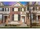 Charming brick townhome featuring a cozy front porch and well-maintained landscaping at 3818 S Dallas St, Aurora, CO 80014