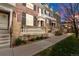 Street view of well-maintained townhomes showcasing brick exteriors and front patios at 3818 S Dallas St, Aurora, CO 80014