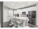Modern kitchen with stainless steel appliances, granite countertops, and a functional island at 3818 S Dallas St, Aurora, CO 80014