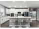 Well-lit kitchen featuring a center island with barstool seating and modern appliances at 3818 S Dallas St, Aurora, CO 80014
