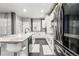 Bright, modern kitchen with an island, stainless appliances, and ample counter space at 3818 S Dallas St, Aurora, CO 80014