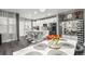 Bright, open kitchen features white cabinetry, stainless steel appliances, and a large island with seating at 3818 S Dallas St, Aurora, CO 80014