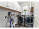 Functional laundry room with modern washer and dryer, ample cabinet space, and natural light at 3818 S Dallas St, Aurora, CO 80014