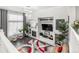 Open-concept living room with modern lighting, a fireplace, and stylish decor at 3818 S Dallas St, Aurora, CO 80014