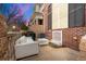 Outdoor patio with white wicker furniture, a grill, and a view of the surrounding architecture at 3818 S Dallas St, Aurora, CO 80014