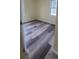 Bright bedroom featuring a window, light walls and modern wood-look flooring at 1940 Quince St, Denver, CO 80220