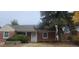 Charming brick home featuring mature landscaping at 1940 Quince St, Denver, CO 80220