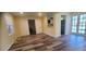 Open-concept living room with updated flooring, leading to an adjacent kitchen space at 1940 Quince St, Denver, CO 80220