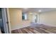 Spacious room featuring updated flooring and neutral color palette, with an opening to the kitchen area at 1940 Quince St, Denver, CO 80220