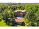 Sprawling property with brick home, a three-car garage, mature landscaping and adjacent outbuilding and green lawns at 4181 S Colorado Blvd, Cherry Hills Village, CO 80113