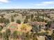 A large property that includes mature landscaping, a tennis court, and other recreational areas at 4181 S Colorado Blvd, Cherry Hills Village, CO 80113