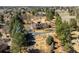 Aerial view of a charming estate featuring mature trees, tennis court, circular driveway, and well-maintained landscaping at 4181 S Colorado Blvd, Cherry Hills Village, CO 80113