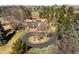 Expansive home aerial view, showcasing circular drive, mature trees, tennis court, and surrounding landscape at 4181 S Colorado Blvd, Cherry Hills Village, CO 80113