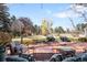 Serene backyard retreat features a brick patio, lush lawn, mature trees, and comfortable seating arrangement at 4181 S Colorado Blvd, Cherry Hills Village, CO 80113