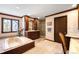 Luxurious bathroom with a soaking tub, double vanity, and tiled walk-in shower at 4181 S Colorado Blvd, Cherry Hills Village, CO 80113