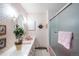 Bright bathroom with floral wallpaper, pink fixtures, and a tiled shower at 4181 S Colorado Blvd, Cherry Hills Village, CO 80113