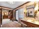 Vanity area leading to a walk-in closet, featuring a stylish mirror and ample storage space at 4181 S Colorado Blvd, Cherry Hills Village, CO 80113
