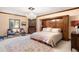 Serene bedroom with built-in headboard storage, chandelier, and plush rug at 4181 S Colorado Blvd, Cherry Hills Village, CO 80113