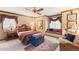 Comfortable bedroom with a window seat, vintage trunk, and a ceiling fan at 4181 S Colorado Blvd, Cherry Hills Village, CO 80113
