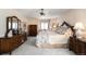 Bedroom featuring wood furniture, bed with decorative pillows, and large window sitting area at 4181 S Colorado Blvd, Cherry Hills Village, CO 80113